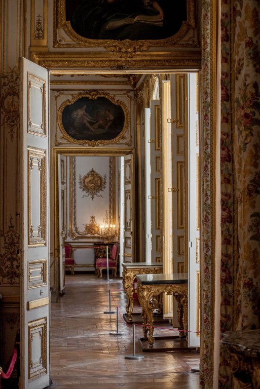A grand corridor inside the Palace of Versailles.