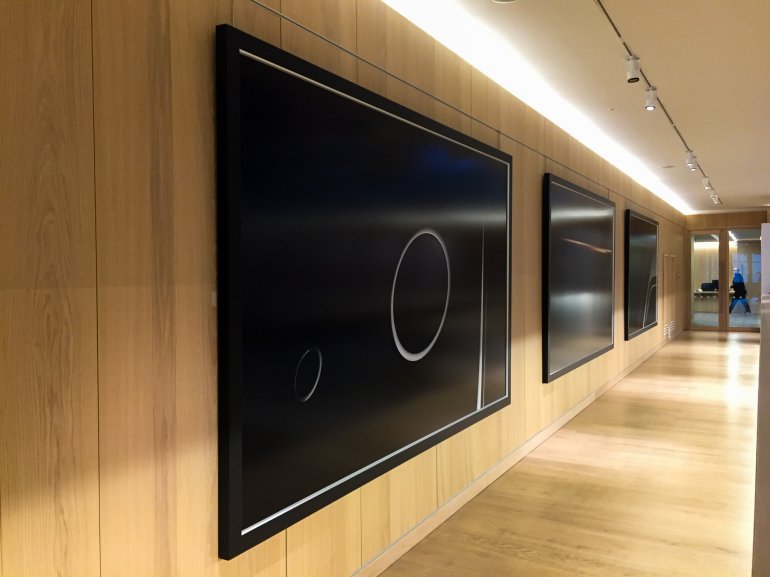 Large artworks hanging from a wall using Absolute artwork hanging solutions in the atrium of The Design Museum, London.  Large artworks hanging from a wall using Absolute artwork hanging solutions in the atrium of The Design Museum, London.