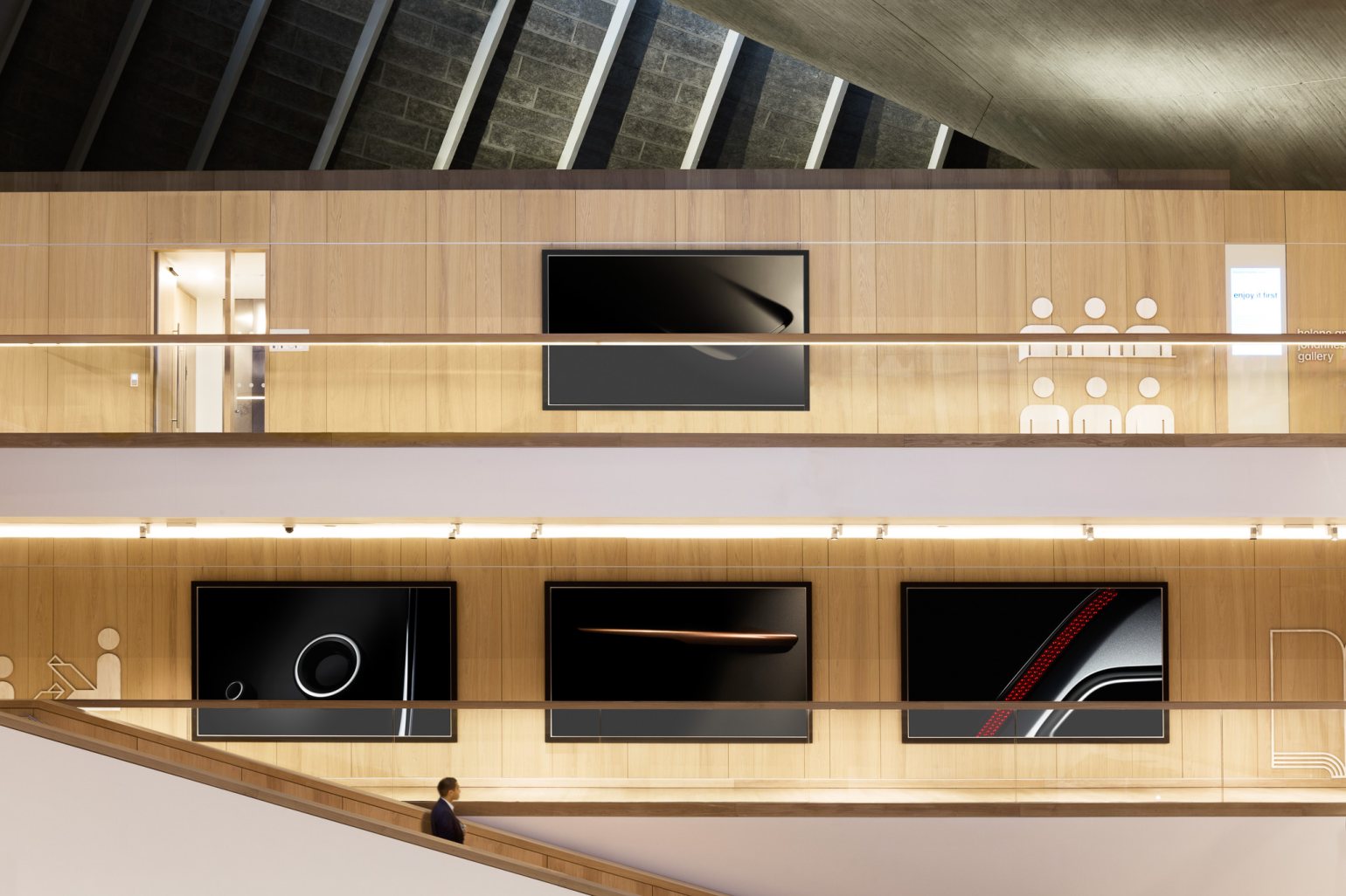 Wide shot of the atrium in The Design Museum, London, showing artwork hanging from walls on different floor levels. The artworks are mounted with Absolute track hanging systems.  Wide shot of the atrium in The Design Museum, London, showing artwork hanging from walls on different floor levels. The artworks are mounted with Absolute track hanging systems.