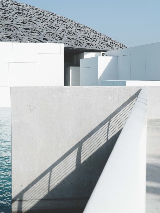 External shot of Louvre Abu Dhabi, highlighting the different architectural textures and the silvery domed roof.  External shot of Louvre Abu Dhabi, highlighting the different architectural textures and the silvery domed roof.