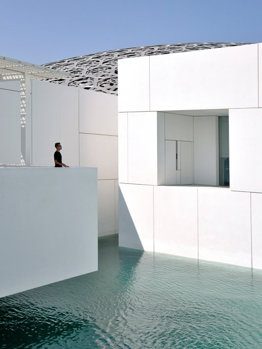 A person looking at the external architecture of Louvre Abu Dhabi. A person looking at the external architecture of Louvre Abu Dhabi.