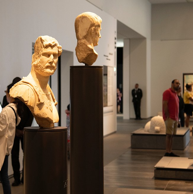 Two historic stone sculptures of the heads of two different men on display at Louvre Abu Dhabi. Two historic stone sculptures of the heads of two different men on display at Louvre Abu Dhabi.
