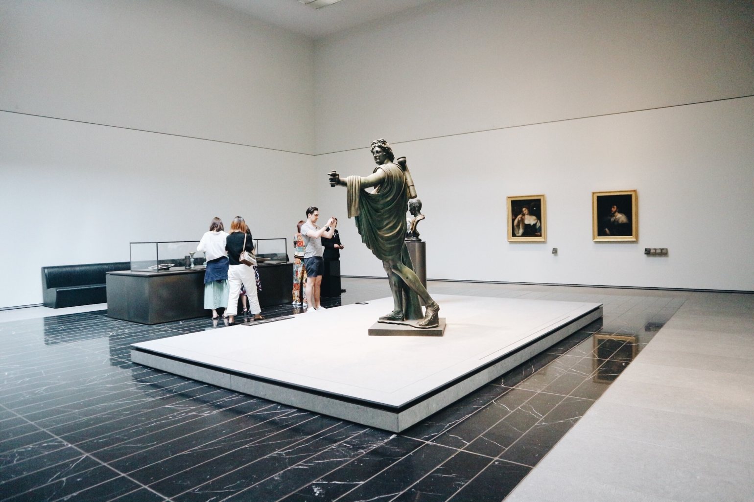 An exhibit on display at Louvre Abu Dhabi, featuring historic portrait paintings and a bronze statue. An exhibit on display at Louvre Abu Dhabi, featuring historic portrait paintings and a bronze statue.