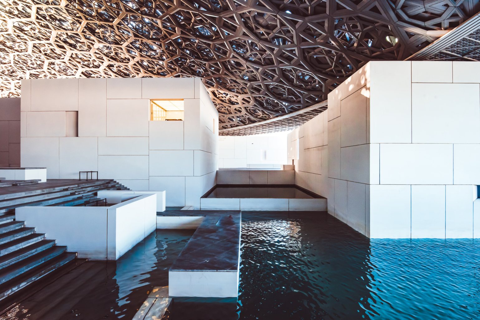 Part of Louvre Abu Dhabi, highlighting the differing architectural textures connecting the museum from land to sea. Part of Louvre Abu Dhabi, highlighting the differing architectural textures connecting the museum from land to sea.