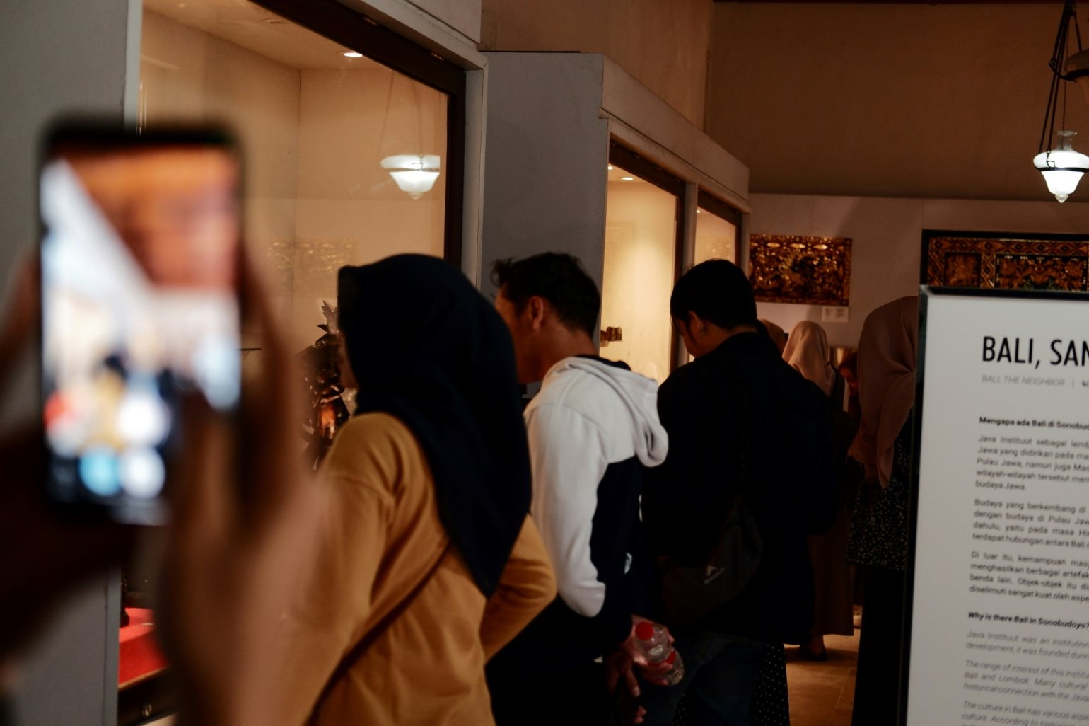 Group of visitors at a museum, viewing the exhibits.