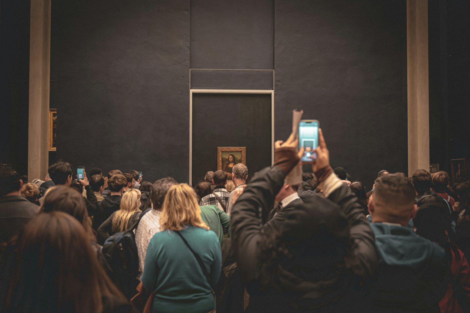 Mona Lisa painting on display in museum with large crowds
