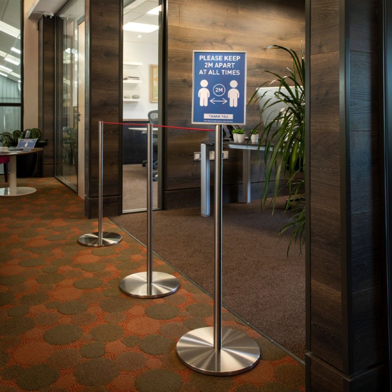 An office environment using Absolute Freestanding Barriers adapted to carry a label holder, displaying social distancing information. An office environment using Absolute Freestanding Barriers adapted to carry a label holder, displaying social distancing information.