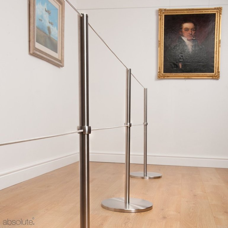 Absolute Freestanding Barriers with Q Barrier Cuff and an extra line of Barrier Cord, protecting artwork in a gallery. Absolute Freestanding Barriers with Q Barrier Cuff and an extra line of Barrier Cord, protecting artwork in a gallery.