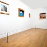 Absolute Surface Mounted Barriers protecting multiple wall mounted artworks in an art gallery.