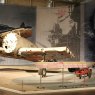 Museum exhibition featuring war plane and extensive related information on reader rail.