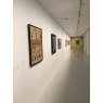 Artworks in a gallery fixed to a wall using Ryman hangers.