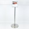 Stainless steel Freestanding Q Barrier with barrier cord, and signage plate connected via signage adaptor.