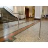 Absolute Surface Mounted Q Barriers in stainless steel installed in a museum foyer.